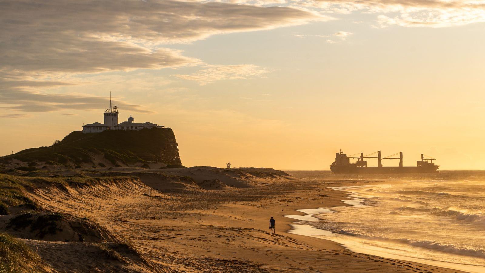 Nobbys Beach and Nobbys Head lighthouse, Newcastle NSW, at sunrise